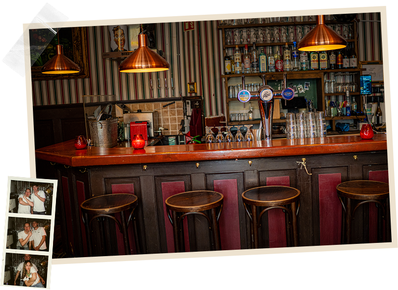 The bar at Café Joost in Utrecht with copper lamps and bar stools